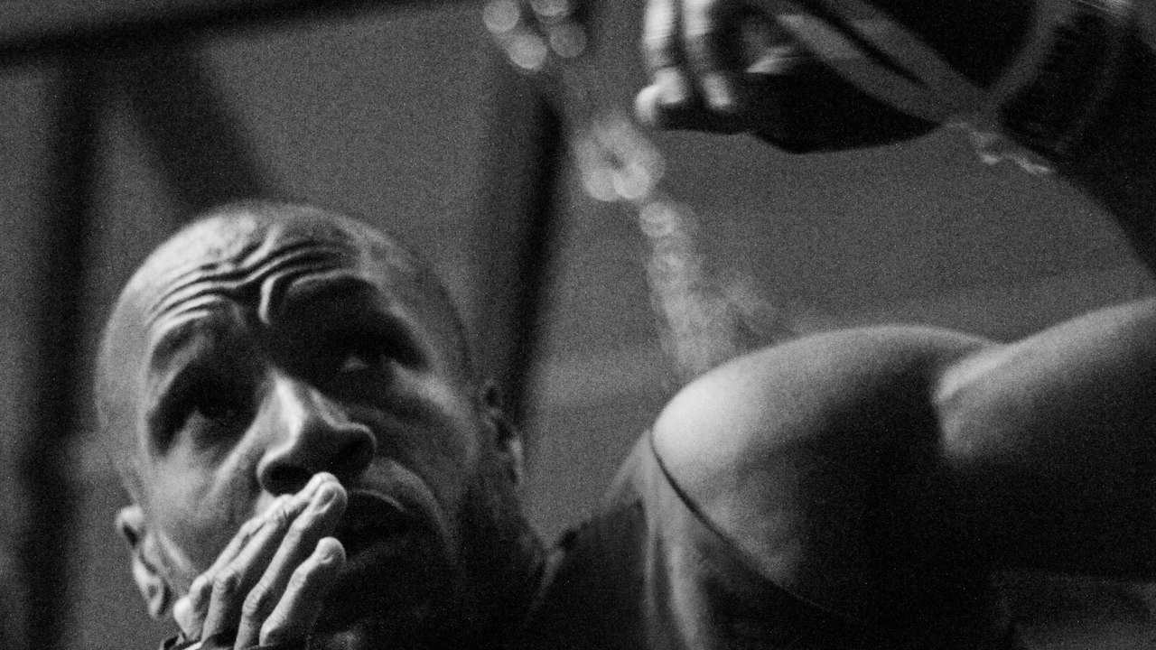 A boxer shadow boxing, in black and white